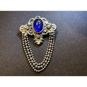 Silver Tone Filigree Blue Cabochon and Chain Dangles Brooch